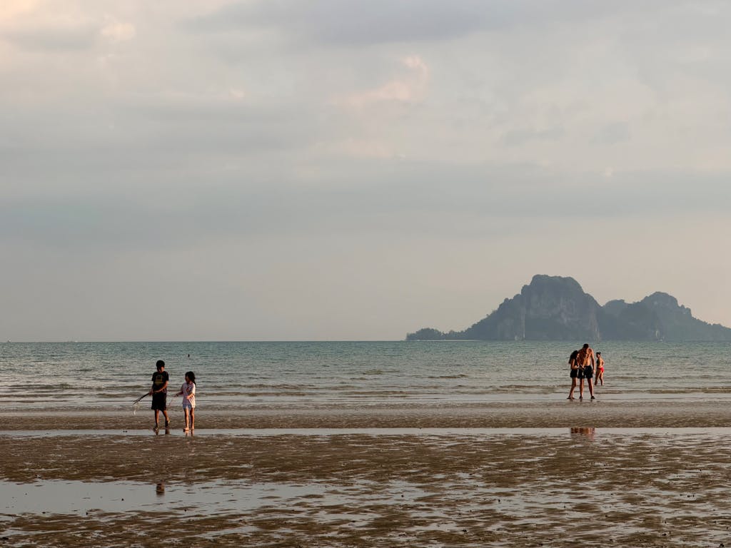 Enjoy a peaceful walk along Samila Beach at sunset in Songkhla, Thailand.