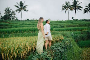 A couple enjoying the lush greenery of Bali's famous rice terraces. Perfect for travel and lifestyle imagery.